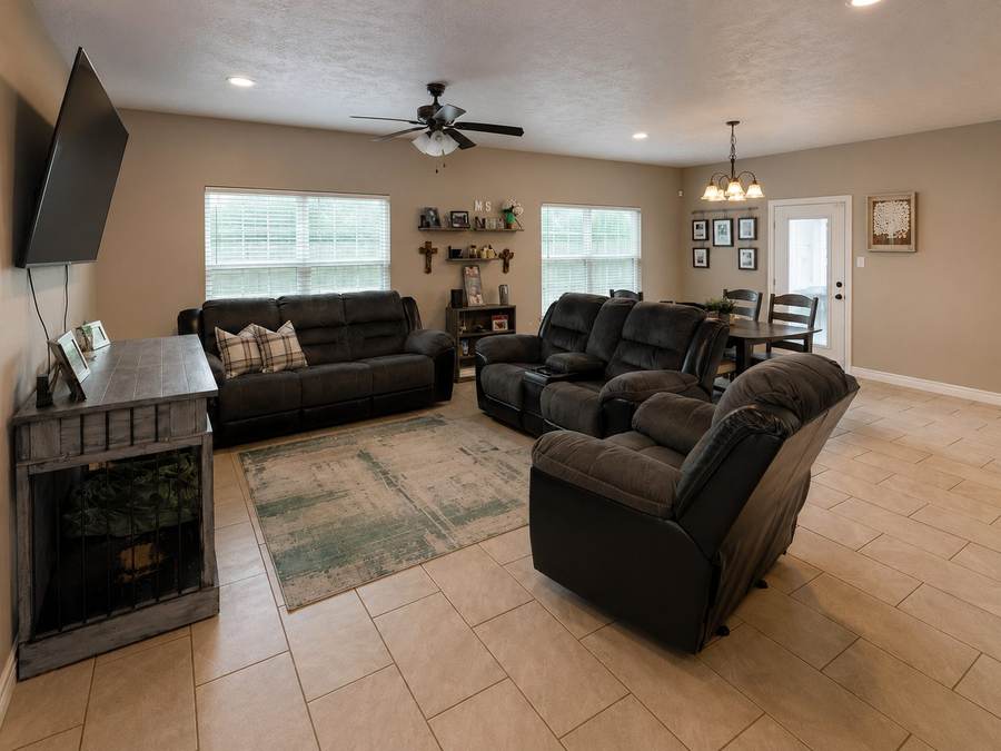 The same living room before the remodel: darker paint, no fireplace, older furniture